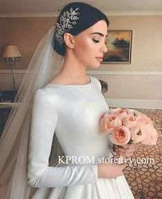 a woman in a wedding dress holding flowers