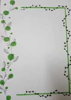 a piece of paper that has been cut out to look like a frame with leaves and berries on it