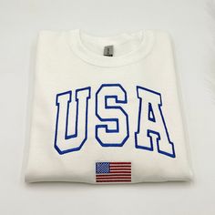 USA Flag Embroidered Sweatshirt All hoodies and crewneck sweatshirts are fleece. 65% cotton 35% poly Care instructions: Machine cold wash, inside out, with like colors. Only non-chlorine bleach. Tumble dry low. Medium iron. Do not iron decoration. Double-needle stitched neckline, bottom hem and sleeves t-shirt. Unisex sizing. Size chart is available in the listing photos. All measurements are approximate. Measurements may vary about 2″ less or more. White Varsity Crew Hoodie, White French Terry Crew Neck Sweats, White Crew Hoodie With Embroidered Graphics, White Hoodie With Embroidered Graphics, White Crew Neck Hoodie With Embroidered Logo, White Embroidered Logo Hoodie With Crew Neck, White Embroidered Logo Crew Neck Hoodie, Cotton Sweater With Letter Embroidery For Streetwear, White Embroidered Crew Hoodie