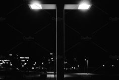 black and white photo of street lights at night