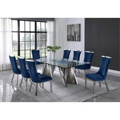 a glass dining table with blue chairs