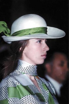 a woman wearing a green and white hat