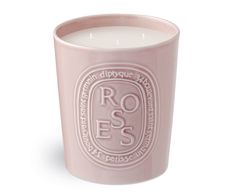 a pink candle with the words roses on it and a white label that reads rose