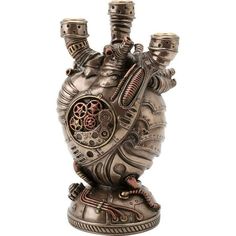 a metal heart shaped vase with two candles in it's center and steampunky gears on the inside