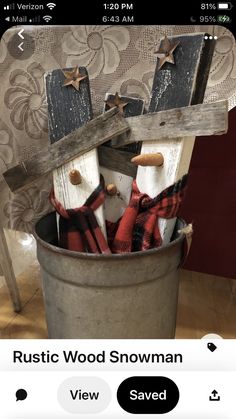 a bucket filled with wooden snowmen sitting on top of a table