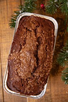 a loaf of chocolate cake sitting on top of a wooden table