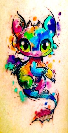 a colorful tattoo on the back of a woman's shoulder with an image of a cat