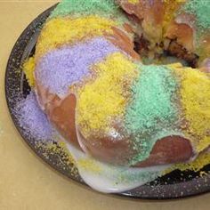 a bundt cake covered in icing and colored sprinkles on a plate