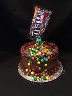 a chocolate cake with candy and candies on top