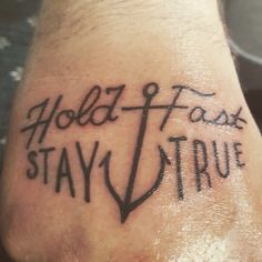 a person with a tattoo on their foot that says hold fast stay true and an anchor