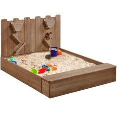 a wooden bed with sand and toys in the bottom part, on a white background