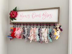 there is a sign that says guess over shoes hanging on the wall next to baby's clothes