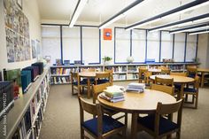 a library with tables, chairs and bookshelves