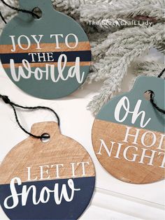 three wooden ornaments with the words joy to the world and let it snow on them