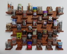 a wooden shelf filled with lots of different types of glasses on it's sides