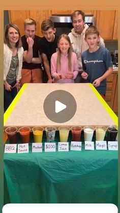 a group of people standing in front of a big board with drinks on it and the words happy birthday