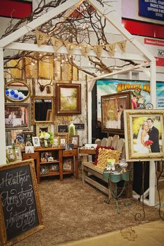 a room filled with furniture and pictures on the wall next to a chalkboard sign