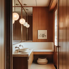 A mid-century modern bathroom with striking pendant lights and minimalist sconces, creating a balanced and visually appealing lighting scheme that sets the mood3 Mid Century Bathroom Cabinet, Mid Century Partition, White Mid Century Bathroom, Disc Interiors Bathroom, Vintage Modern Decor Bathroom, Wood Clad Bathroom, Mid Century Modern Millwork, Bathroom Design Mid Century Modern, Mid Century Slat Wall