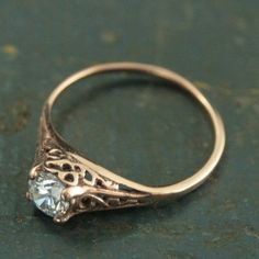 an antique style engagement ring with a diamond in the center