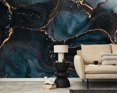 a living room with a couch, chair and wall mural