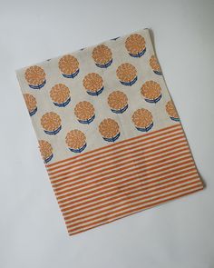 an orange and white cloth with trees on it