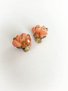 Cute vintage West Germany earrings! Three pink plastic beads in the center bordered with three iridescent hot orange beands andclear orand beads with a gold tone metal caps. Backings are clip on style. Marked W Germany. Overall good condition. Mild wear to beads and mild to modreate wear and tarnish to the metal. 7/8 of an inch wide and 1 inch tall. Discounts offered for bulk purchases. Shop accepts PayPal, credit cards, Etsy gift cards, and postal money orders. ♥Check out the rest of the shop♥ Vintage Orange Beaded Earrings, Orange Beaded Vintage Earrings, Vintage Orange Earrings For Party, Orange Vintage Earrings For Party, Hot Orange, Earrings Clip, Vintage Wine, Pink Plastic, Orange And Pink