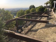 several benches sitting on top of a dirt hill