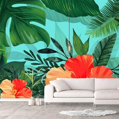 a living room filled with furniture and lots of tropical plants on the wall behind it