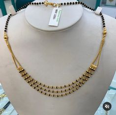 a gold necklace on display in a store