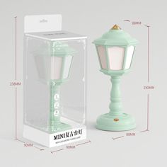 the purple lamp is next to the box for it's packaging design and instructions