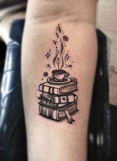 a stack of books with a steaming coffee cup on top of them tattoo design idea