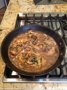 a skillet filled with food sitting on top of a stove next to an oven