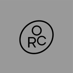 a black and white circle with the word rcc in it on a gray background