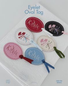 four round tags on a white towel with the words eyelet oval tag printed on them