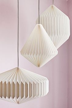 three white paper lamps hanging from the ceiling