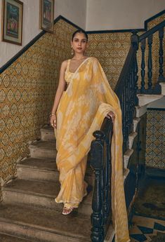 Embrace the warmth of the sun with the Marisol Saree, a radiant piece crafted in bright yellow linen. This saree captures the essence of joy and light, with its soft, breathable fabric draping effortlessly around you. Whether you're attending a daytime event or simply celebrating the beauty of life, this saree is a celebration of sunshine and grace, wrapping you in its cheerful embrace. MODEL DETAILS Model Name- Raghvi Sehgal Bust- 32.5 Arms- 10.9 Hips-37 Height - 5.6 Fabric: 100% Linen Characte Traditional Summer Pre-draped Saree With Zari Work, Summer Bollywood Pre-draped Saree, Yellow Blouse Piece With Sheer Dupatta, Summer Chanderi Blouse With Sheer Dupatta, Summer Sheer Dupatta Blouse In Chanderi, Summer Pre-draped Georgette Saree With Sheer Dupatta, Fitted Yellow Pre-draped Saree With Zari Weaving, Summer Georgette Pre-draped Saree, Summer Pre-draped Saree With Dupatta In Traditional Drape