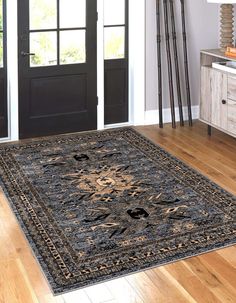 a black and gold area rug in front of a door