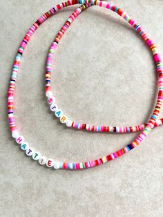 New to BaeKCreations these stretch name necklaces for girls. You'll receive ONE beaded stretch necklace. Customize how you would like, names, words options are endless  Necklaces are made with durable stretchy cord and are meant to stretch over over the head and do not contain a clasp. Beads are a rainbow mix Specific colors may  not be requested  Product Details Heishi Bead Acrylic Letter Beads Durable Elastic Cord Shop Disclaimer  Beads are small and can present a choking hazard for children. Rainbow Beaded Necklace, Necklaces For Girls, Name Choker, Heishi Necklace, Name Necklaces, Acrylic Letters, Rainbow Necklace, Beaded Pendant Necklace, Rainbow Beads