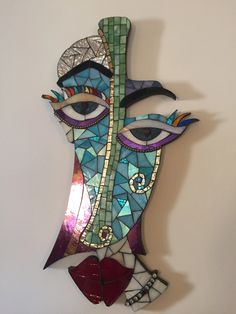 a colorful face made out of stained glass with an eye on it's side