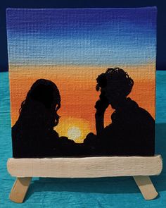 a painting of two people talking on a cell phone in front of an orange and blue sunset