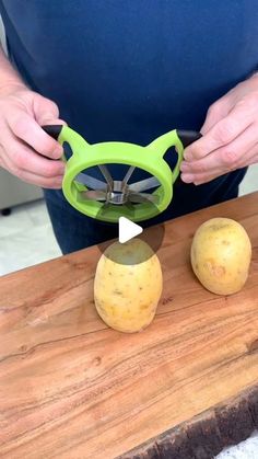 a person cutting potatoes with a pair of scissors