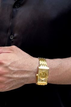 Man wearing VIEREN Gold Stereo Diamond Men's Watch with modern black outfit Elegant Rectangular Gold Jewelry And Watches, Rectangular Yellow Gold Jewelry With Diamond Hour Markers, Gold Rectangular Diamond Watch With Polished Finish, Formal Rectangular Diamond Watch, Luxury Square Formal Watches, Rectangular Yellow Gold Diamond Watch, Luxury Square Watches For Formal Occasions, Classic Gold Rectangular Diamond Watch, Luxury Yellow Gold Rectangular Diamond Watch