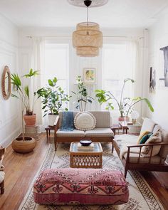 a living room filled with furniture and lots of plants