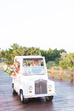 the bride and groom are riding in an old truck