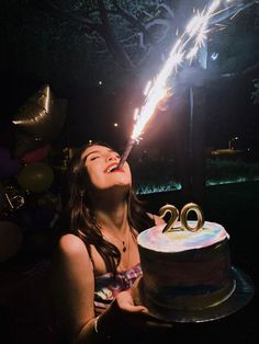 a woman is blowing out the candles on her birthday cake