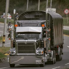 a large semi truck driving down the road