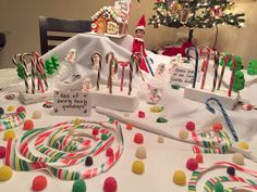 an assortment of candy canes and candies on a table