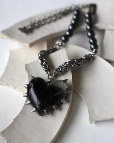 The necklace is made of steel and metal fittings with blackening.  The necklace is short, with a heart pendant relevant for 2024. the spikes are made of steel, the heart is epoxy resin. the author's technique is completely handmade. a glossy-coated heart. The necklace is 19,5 inches long. You can fix the lock in a shorter version. Lock:  1/2 inch carabiner Do not expose to prolonged contact with water, leave in the sun. avoid contact with creams and perfumes. observing these rules, the decoration will delight you for a long time Black Heart-shaped Jewelry For Alternative Fashion, Black Heart Jewelry For Alternative Fashion, Grunge Heart-shaped Metal Necklace, Punk Style Metal Heart Necklace Gift, Punk Style Metal Heart Necklace For Gift, Handmade Edgy Metal Necklaces, Punk Style Heart Necklace For Gift, Handmade Edgy Necklaces For Alternative Fashion, Edgy Handmade Necklaces For Alternative Fashion