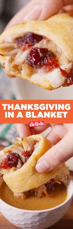 a person holding a turkey in a blanket over a white bowl filled with gravy