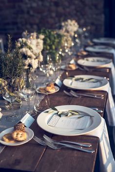 the table is set with plates and silverware